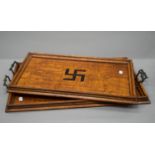 A pair of early 20th century oak trays inlaid with Swastika. The largest 71.5 cm wide.