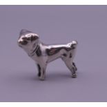 A small 925 silver model of a dog. 2 cm high.