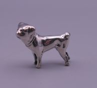A small 925 silver model of a dog. 2 cm high.