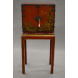 A late 18th/early 19th century chinoiserie lacquered cabinet on associated stand,