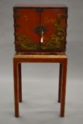 A late 18th/early 19th century chinoiserie lacquered cabinet on associated stand,