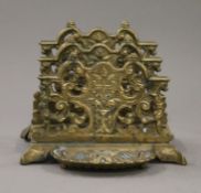 A brass letter rack. 13 cm high.