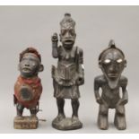 Three African tribal carved wooden figures. The largest 38.5 cm high.