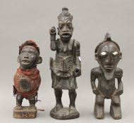 Three African tribal carved wooden figures. The largest 38.5 cm high.