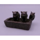 A bronze model of three pigs at a trough. 4.5 cm wide.