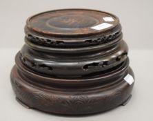 Three Chinese carved wooden stands. The largest 21 cm diameter.
