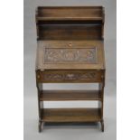 An early 20th century carved oak hall bureau. 75 cm wide.