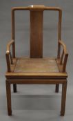 A Chinese hardwood open arm chair. 56 cm wide.