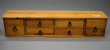 A bank of drawers. 90.5 cm wide, 18 cm deep, 18.5 cm high.