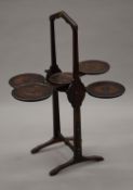 An early 20th century oak folding cake stand. 76.5 cm high.
