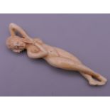 A bone nude medical figure. 8 cm long.