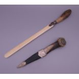 An antler handled sgian dubh and a Victorian ivory letter opener with porcelain handle.