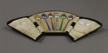 A cased set of silver and enamel tea spoons.