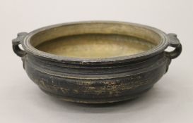 An 18th/19th century Indian patinated bronze Urli temple bowl. 21.5 cm wide.