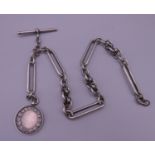 A silver Albert chain and fob. 35 cm long. 58.6 grammes.