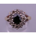 An 18 ct gold diamond and sapphire ring. Ring size O/P. 5.3 grammes total weight.