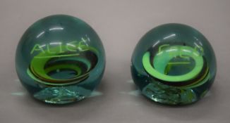 A pair of glass paperweights, one inscribed Fred, the other Alice. The latter 7.5 cm high.