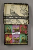 A boxed set of Art Deco dinner guest place cards/cigarette holders.