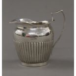 A Victorian silver cream jug. 10 cm high. 159.6 grammes.