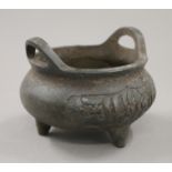 A Chinese bronze censer with Arabic calligraphy decoration. 11 cm wide.