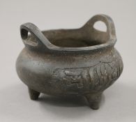 A Chinese bronze censer with Arabic calligraphy decoration. 11 cm wide.