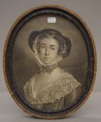 A 19th century print of a Young Lady in an oval carved wooden frame. 35 x 28 cm overall.