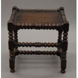 A Victorian oak bobbin twist stool. 49.5 cm wide.