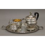 A Victorian three-piece ornate silver plated tea set and a tray.