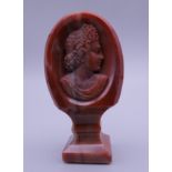 A 19th century agate seal carved with a classical bust. 5.5 cm high.