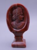A 19th century agate seal carved with a classical bust. 5.5 cm high.