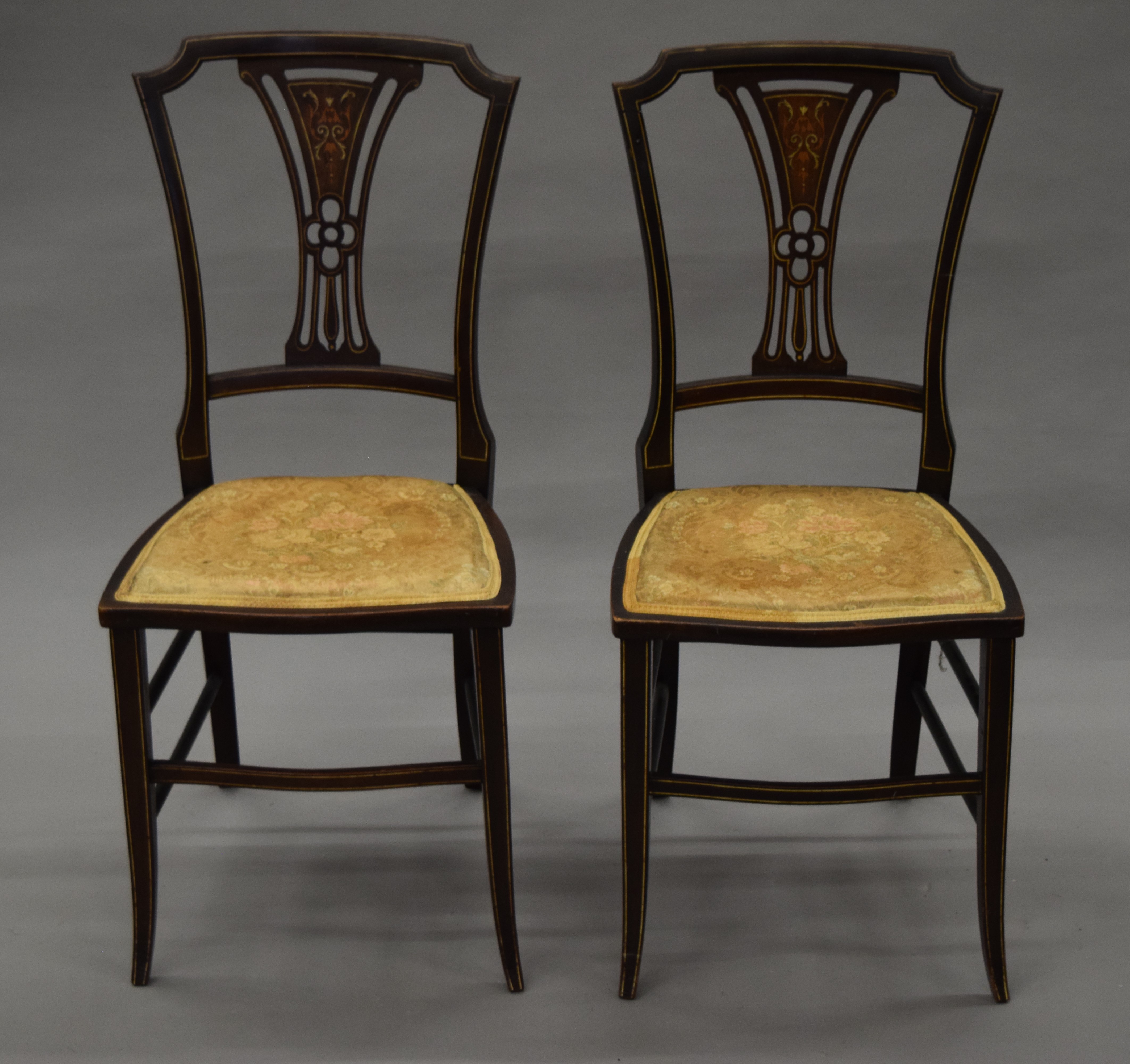 A pair of Victorian inlaid side chairs.