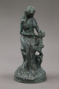 A patinated bronze model of a mother and child. 24 cm high.