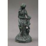 A patinated bronze model of a mother and child. 24 cm high.