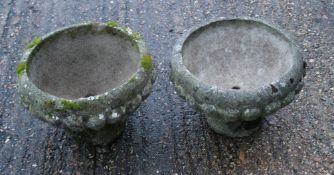 A pair of composition garden urns.
