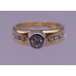 An 18 ct gold seven stone diamond ring. Ring size K. 4 grammes total weight.