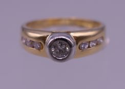 An 18 ct gold seven stone diamond ring. Ring size K. 4 grammes total weight.