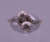 An unmarked gold and platinum diamond crossover ring. Ring size Q/R.