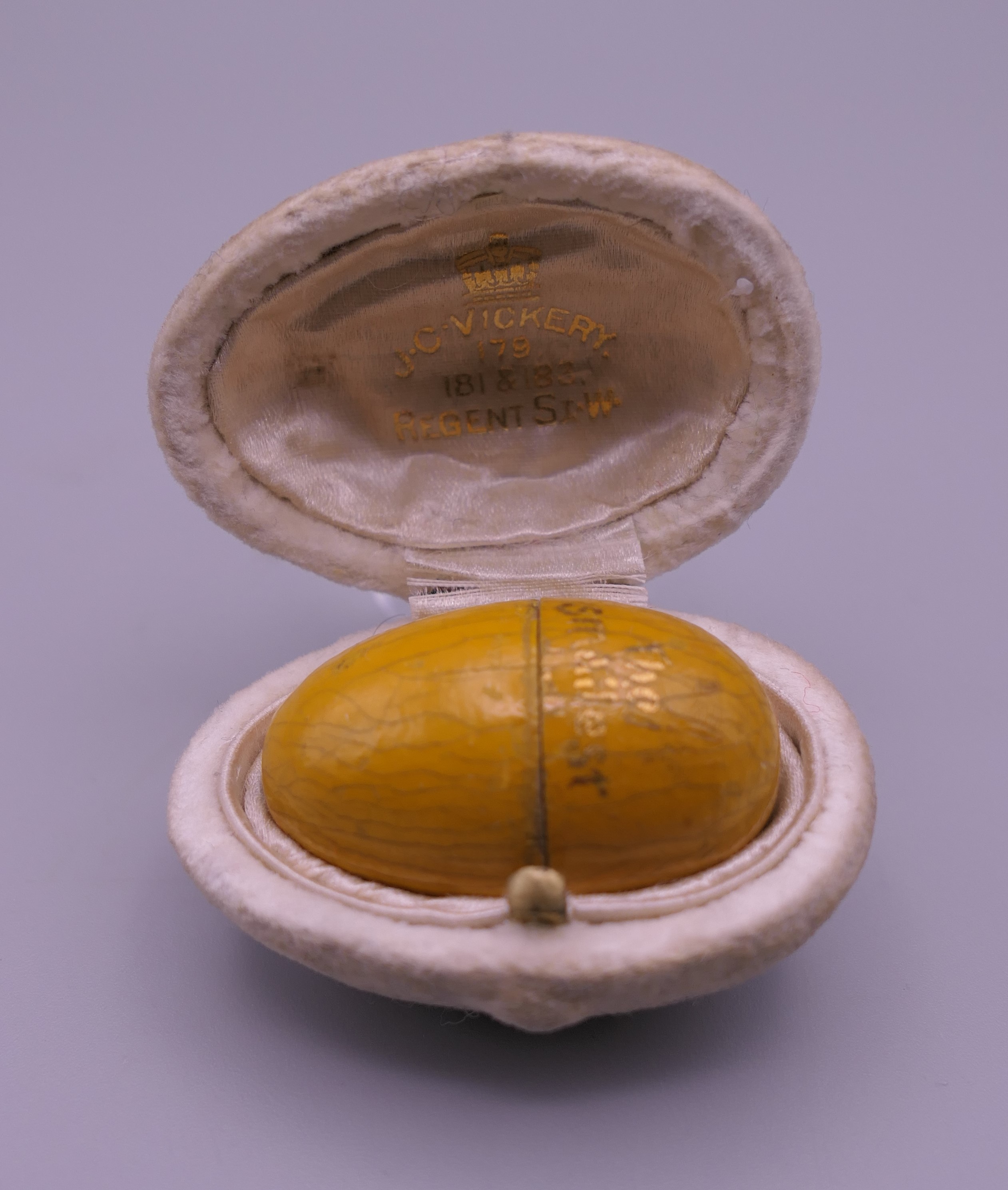 A treen egg form box, inscribed The Smallest Doll? In The World, (lacking doll),