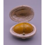 A treen egg form box, inscribed The Smallest Doll? In The World, (lacking doll),