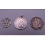 A collection of silver coins, including a Henry VIII silver coin, possibly a groat.