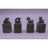 A set of four Chinese bronze seals. 4 cm high.