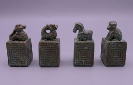 A set of four Chinese bronze seals. 4 cm high.