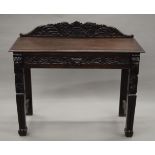 A Victorian carved oak single drawer side table. 106 cm wide.