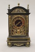 A 19th century brass mounted ebonised bracket clock on stand. The clock 31.5 cm high.