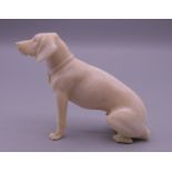 A 19th century carved ivory model of a dog. 6 cm high.