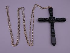 A large Victorian Whitby jet cross on an antique long guard chain. The cross 15 cm high.