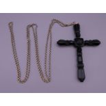 A large Victorian Whitby jet cross on an antique long guard chain. The cross 15 cm high.