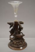 A Blackforest carved centre piece modelled as goats, with a glass flute. 56.5 cm high overall.