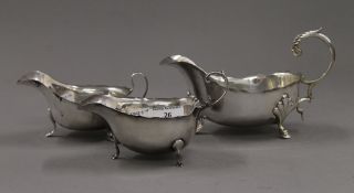 Two silver sauce boats and a larger plated example. The latter 19.5 cm long. 176.