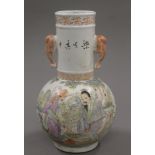 A small Chinese coloured porcelain vase decorated with figures. 23.5 cm high.